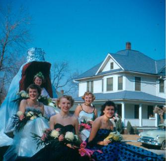 The 1952 Northwest Homecoming Queen and her royal court smile at the crowds during the Homecoming Parade.