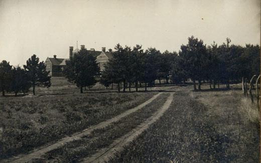 Well-worn dirt path leading up to the Administration Building.   The route, called the "Long Walk," was lined with hundreds of trees - most famously birches.