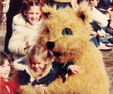 Bobby Bearcat hugs some children during the 1977 Homecoming Parade. 